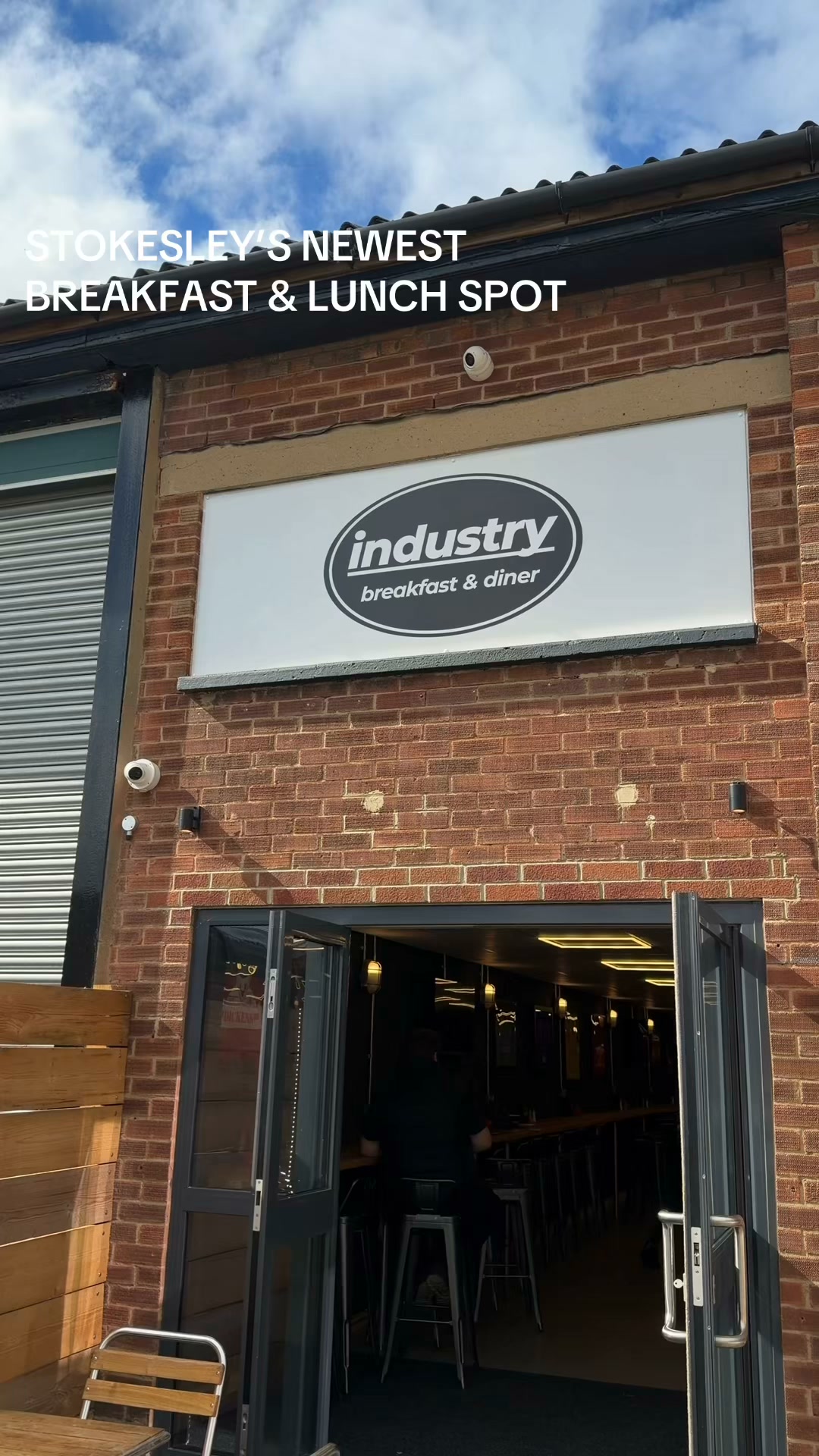 The Industry sign above the open entrance at Unit 28A, with seating visible inside